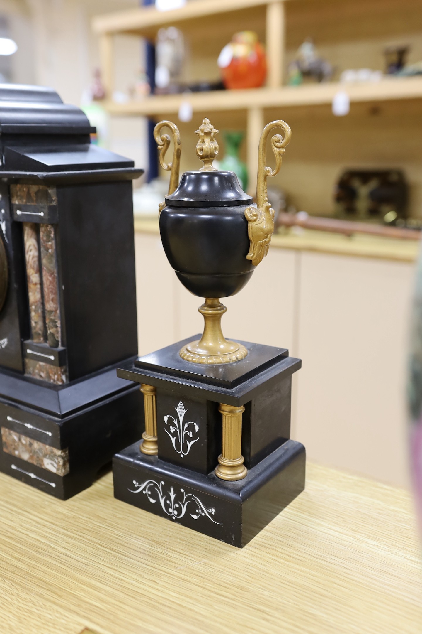 A black slate and marble clock garniture, c. 1890, clock 33cms high